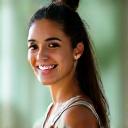 Sarah K, a RYT 200 yoga instructor, smiling confidently in a clean studio setting.